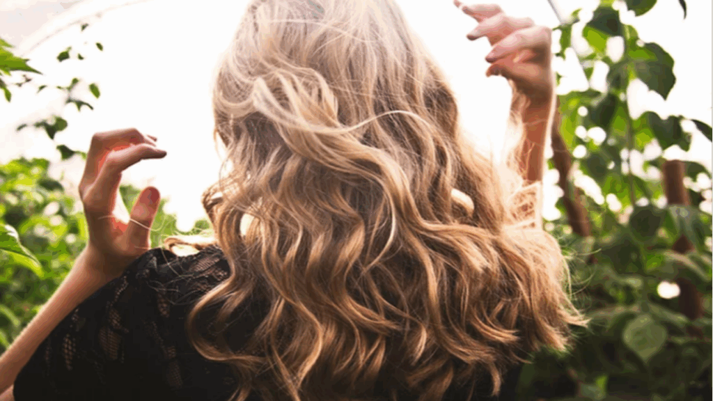 Wavy, voluminous blonde hair cascading down the back.