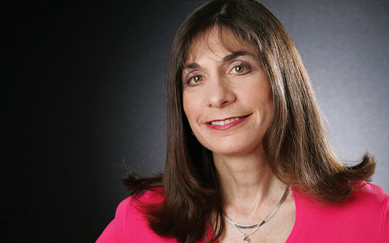 A potted plant next to an open book with text about free resources.