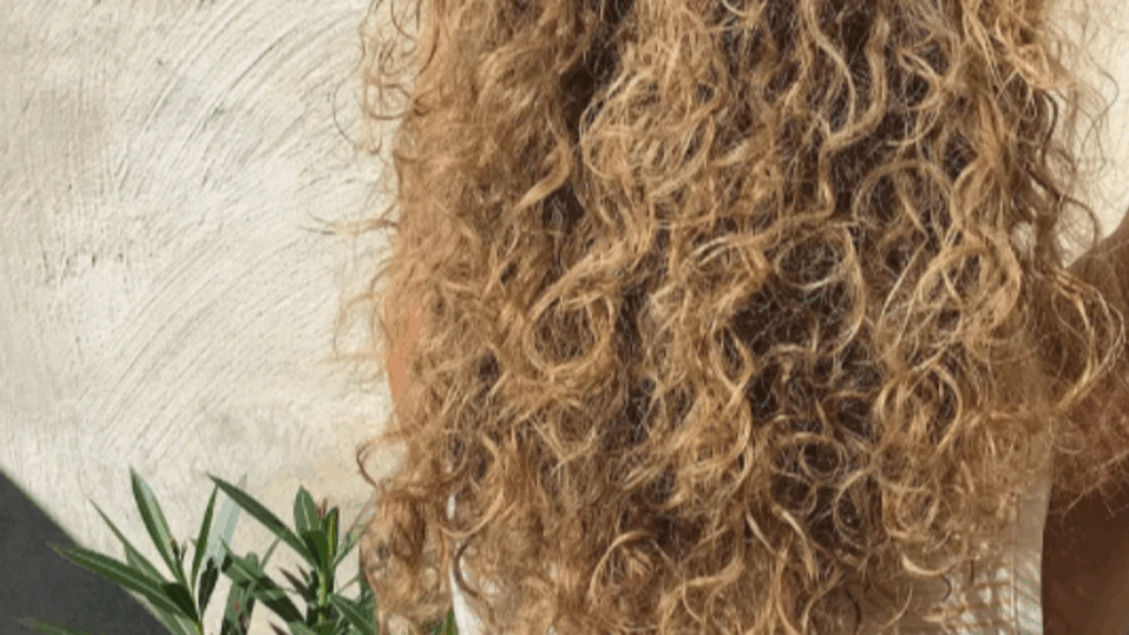 Close-up of long, curly blonde hair.